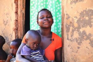 A mother with her child who was successfully classified and treated for an ear infection and pneumonia by an MCSP-supported health facility. 