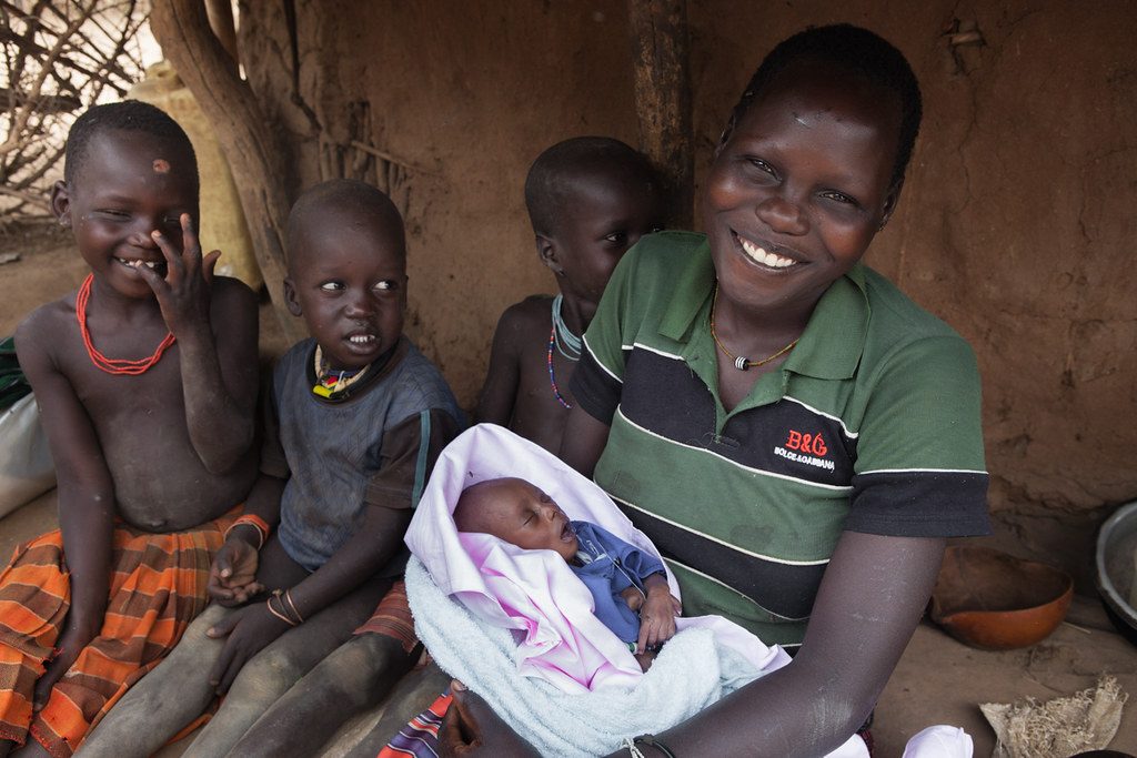 A Ugandan mother and her children at home.